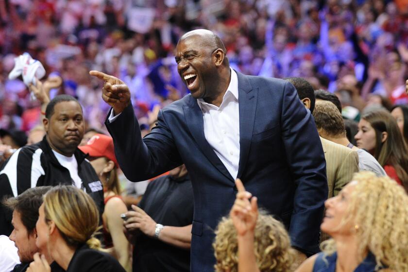 Magic Johnson, attacked on CNN by Donald Sterling, points to the court after the Clippers defeated the Thunder in Game 4 of the NBA Western Conference playoffs at Staples Center on Sunday.