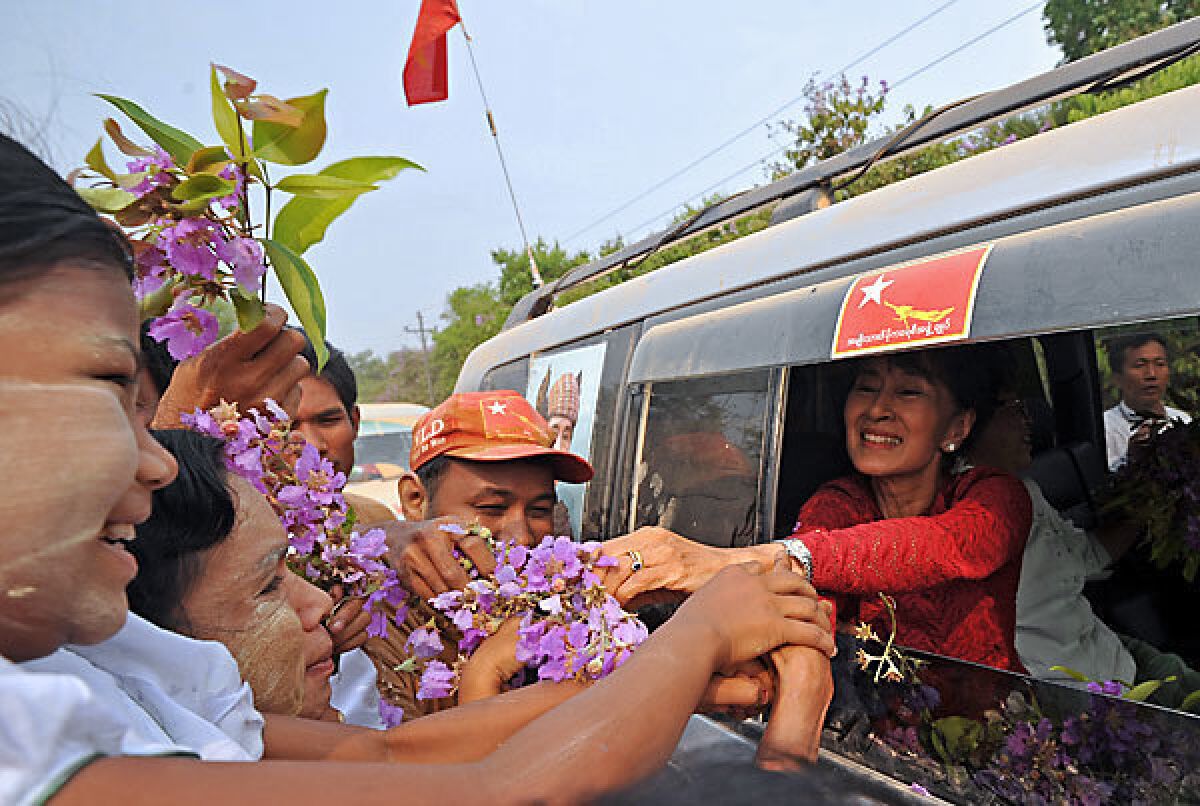 Myanmar opposition leader Aung San Suu Kyi greets supporters as she travels across her constituency in Kawhmu. The elections seen as a test of the government's budding reforms, with opposition leader Aung San Suu Kyi standing for a seat in parliament for the first time.