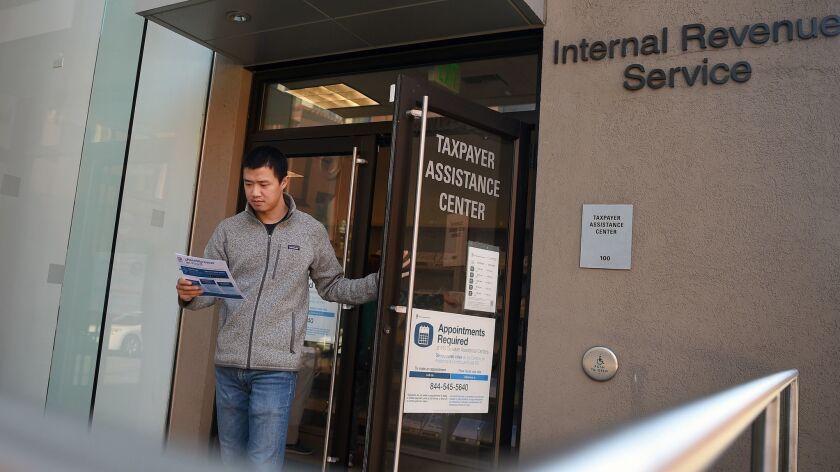 San Jose resident Leo Wang visits an IRS office to obtain a document as he prepares to leave the country after being denied an H-1B visa.