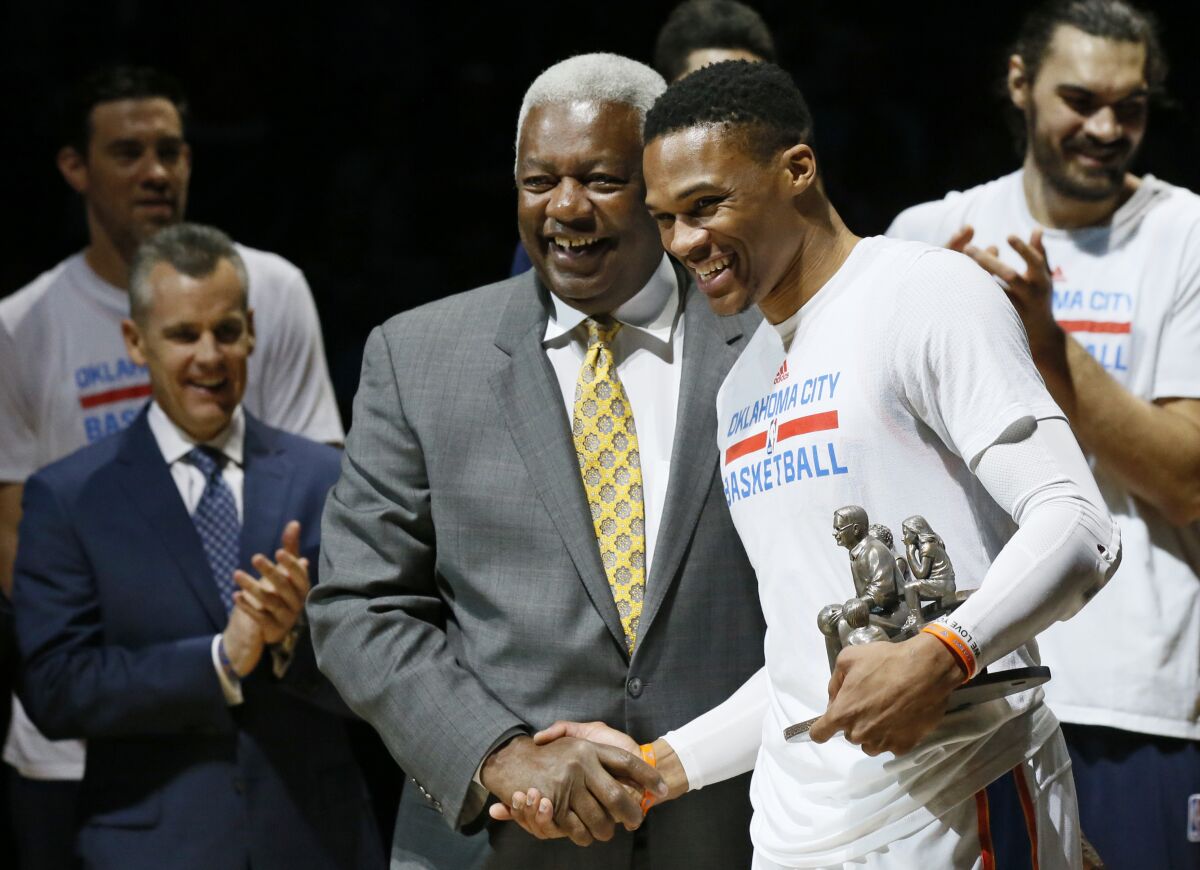 FILE - Then-Oklahoma City Thunder guard Russell Westbrook, right, is congratulated by Oscar Robertson on his single season triple-double record before an NBA basketball game between the Denver Nuggets and the Oklahoma City Thunder in Oklahoma City, Okla., in this Wednesday, April 12, 2017, file photo. Westbrook’s stat lines have been looking like typos in the box score lately, and now he’s on the verge of something historic. The Washington Wizards point guard’s next triple-double – which could come as soon as Saturday, May 8, 2021, will be the 181st of his career, tying Oscar Robertson’s NBA record. (AP Photo/Sue Ogrocki, File)