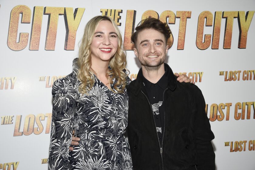 Erin Darke and Daniel Radcliffe standing next to each other at a red carpet
