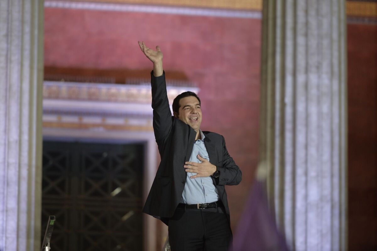 Alexis Tsipras, leader of the radical left Syriza party, greets supporters in Athens on Sunday, claiming victory in the national election.