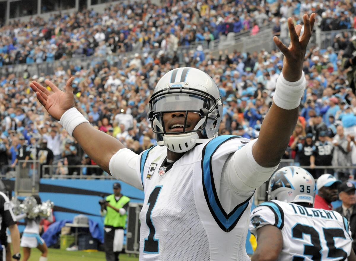 Carolina's Cam Newton celebrates a touchdown run against New Orleans on Sunday.