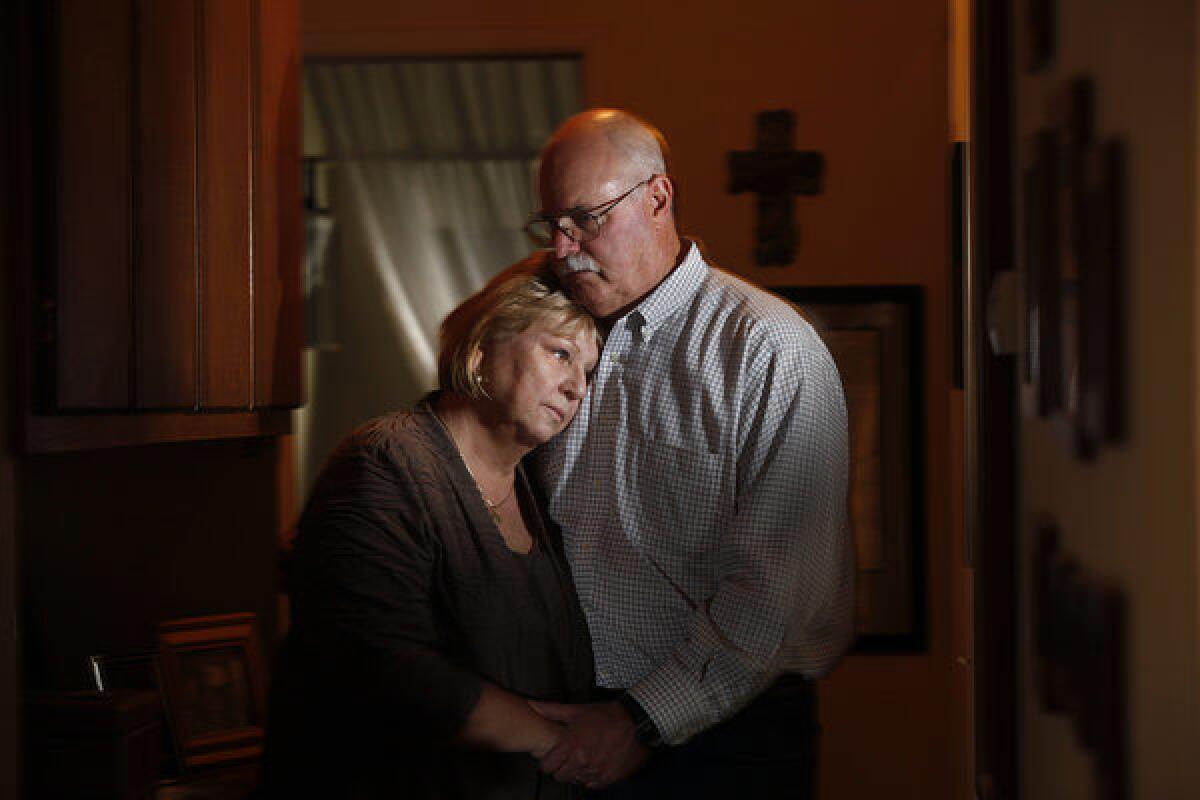 Bonnie and Danny McAlpin stand in their home, not far from the place where their son, Rusty McAlpin, committed suicide four months after he left the Army. The transition had been hard on him, Bonnie McAlpin said. "He never wanted to seem weak."