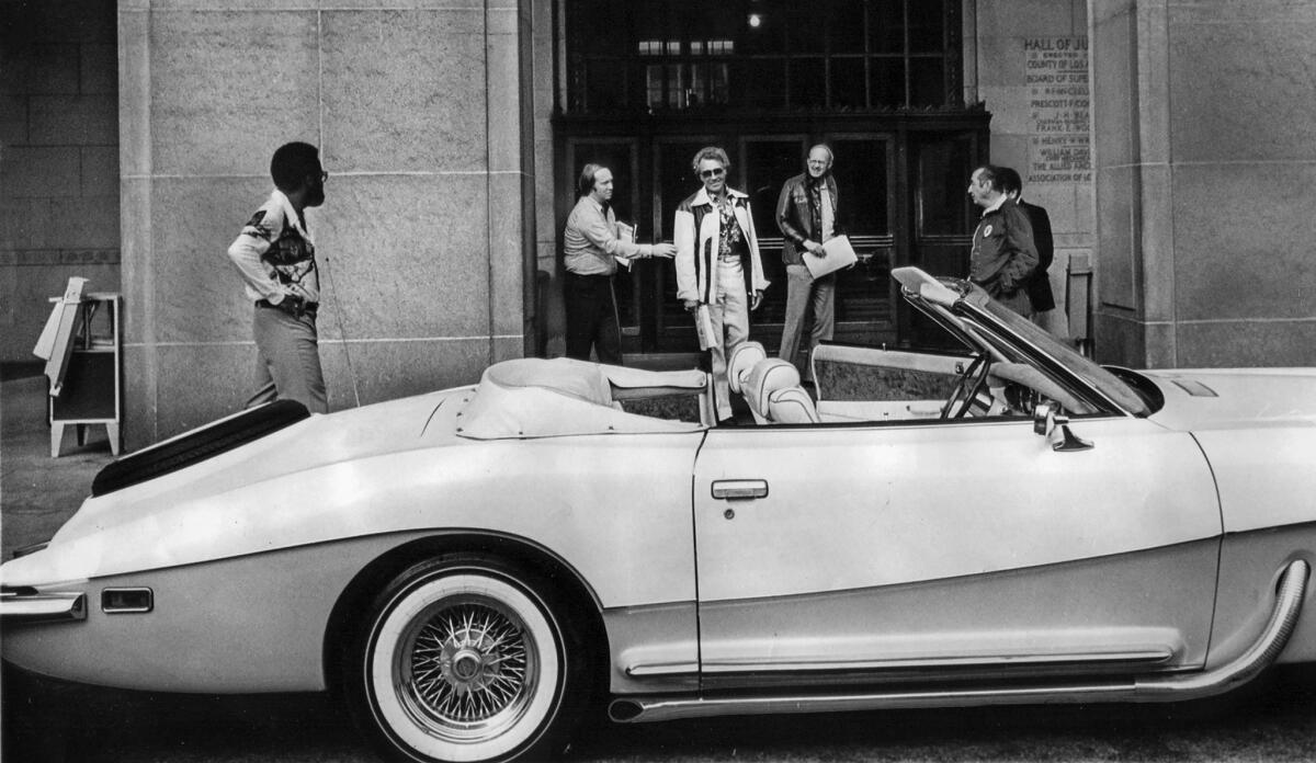Dec. 12, 1977: Evel Knievel, dark glasses center, leaving the Spring Street side of the Hall of Justice. The car is Knievel's Stutz convertible.