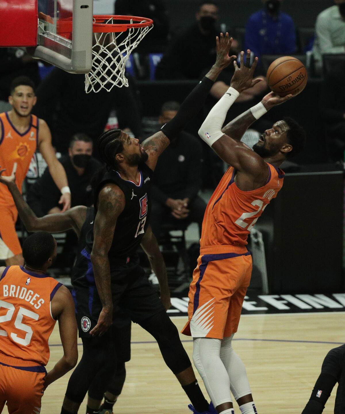Suns center Deandre Ayton scores over Clippers forward Paul George during Game 6.
