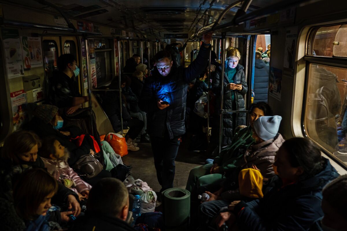 Hundreds of people seek shelter underground and inside the dark train cars.