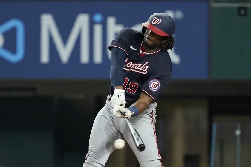 Washington Nationals' Josh Bell connects for a run-scoring single in the eighth inning of a baseball game against the Texas Rangers, Friday, June 24, 2022, in Arlington, Texas. Juan Soto scored on the hit. (AP Photo/Tony Gutierrez)