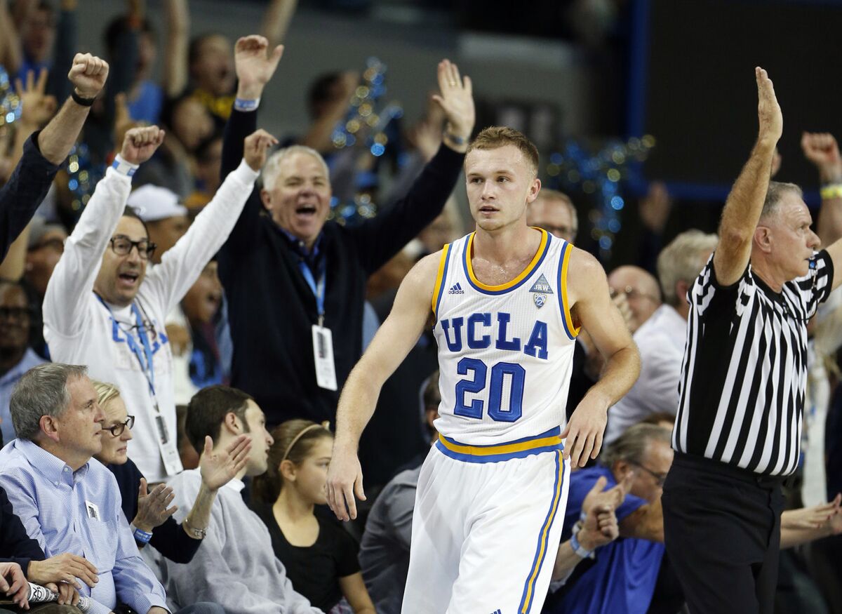 Fans celebrate after Bryce Alford made a three-pointer against Arizona at the end of the first half.