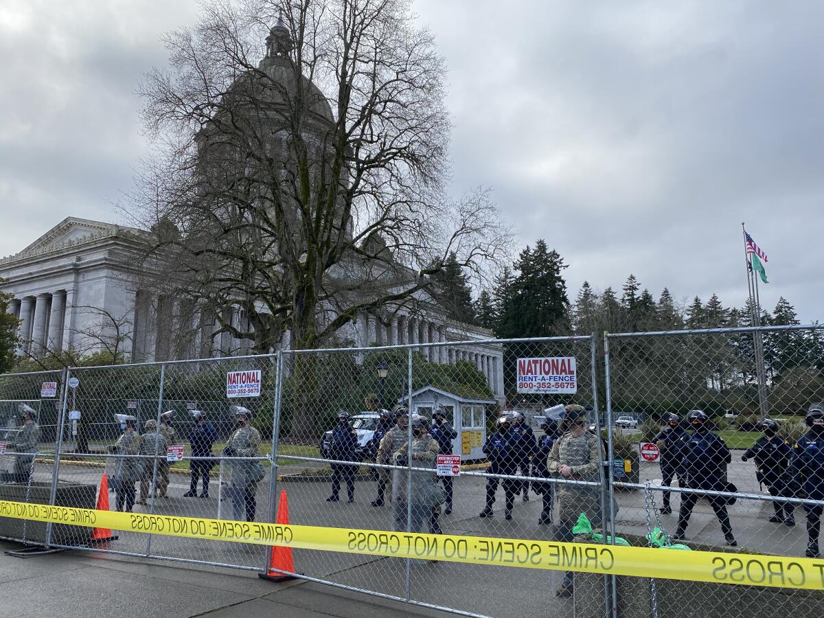 National Guard troops and state troopers guard a fenced-off Washington state Capitol in Olympia on Sunday.