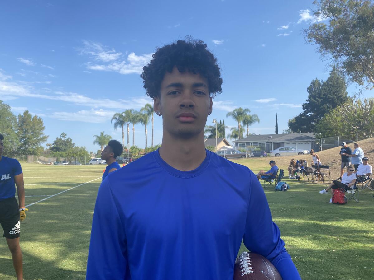 Junior quarterback Malachi Nelson of Los Alamitos stands with a football under his arm.