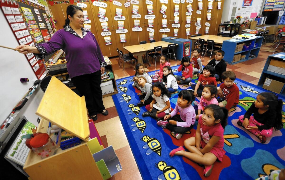 Teacher Celia Cendejas leads preschool students in the School Readiness Language Development Program at Dorris Place Elementary School in Los Angeles.