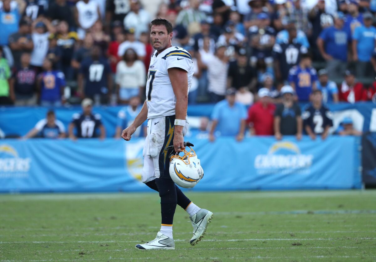 Chargers quarterback Philip Rivers walks off the field in the final moments of the Chargers' 27-20 loss to the Houston Texans on Sunday.