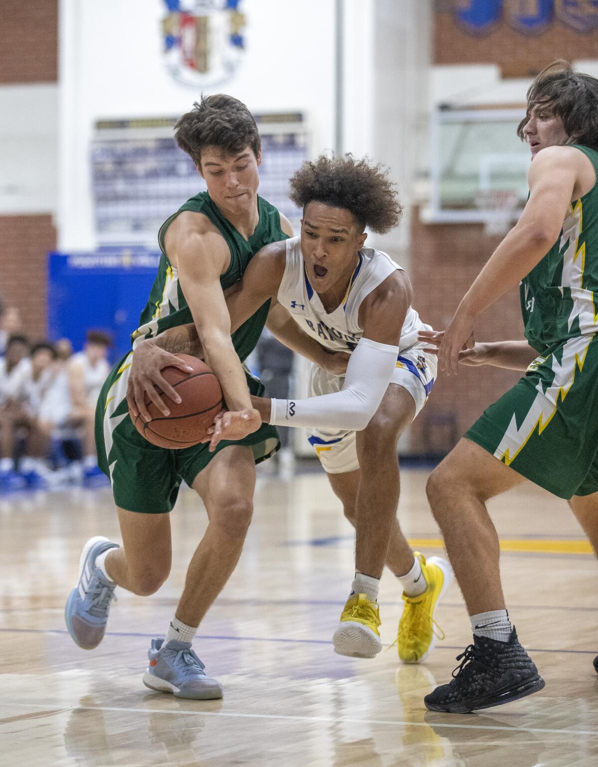 Fountain Valley's Roddie Anderson and Edison's Bradley Luna battle for a ball during Wednesday night's game.