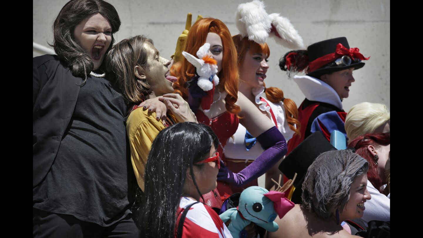 Cosplayers loosen up during a group photo at Comic-Con 2016.