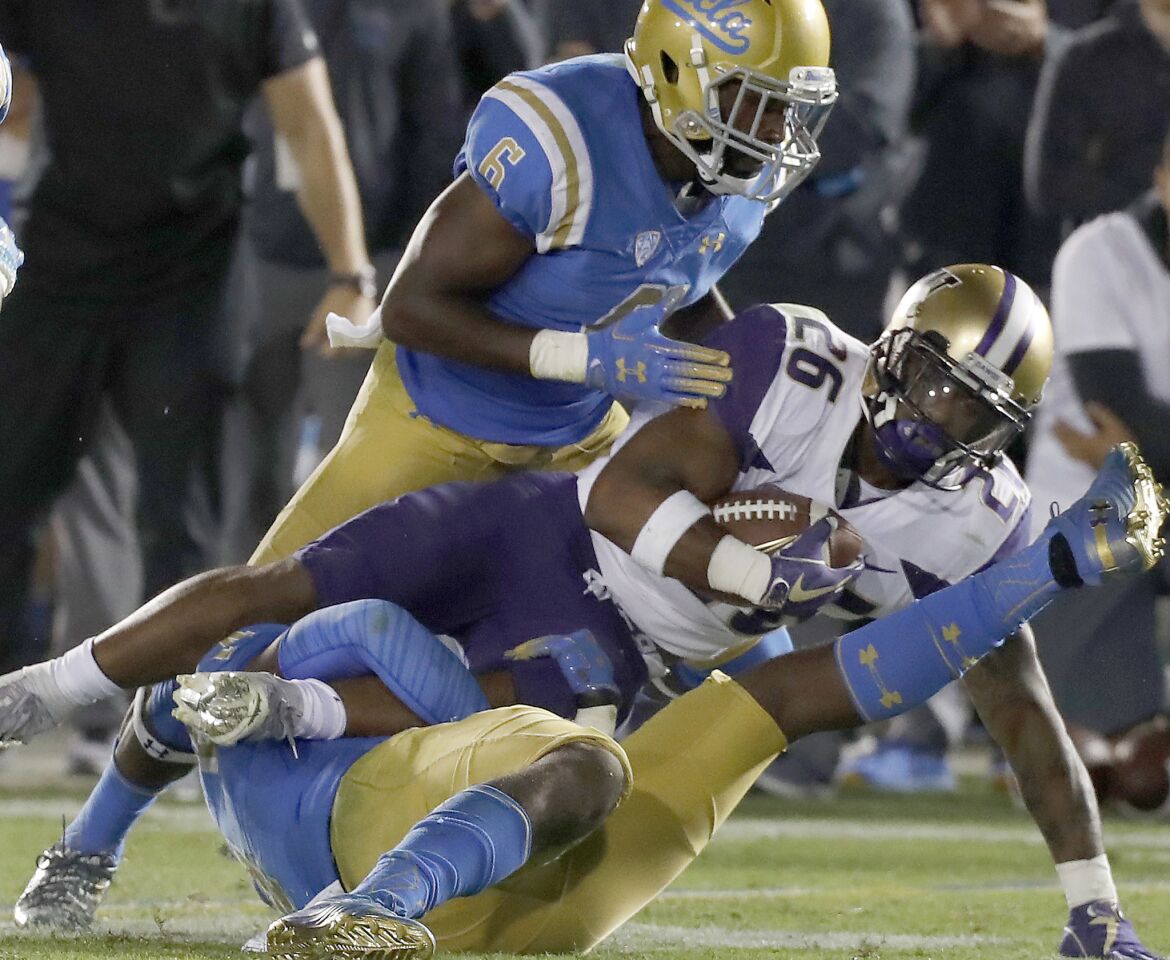 Washington tailback Salvon Ahmed grinds up yardage against UCLA in the second half on Saturday at the Rose Bowl.