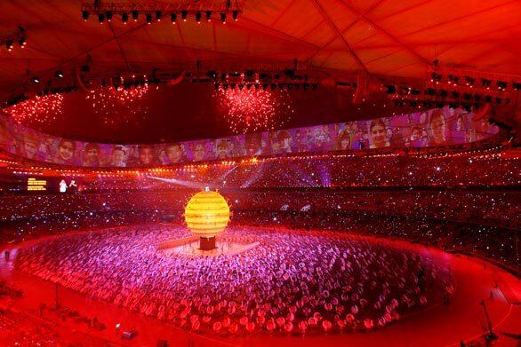 Sarah Brightman and Liu Huan sing on top of a large globe during the opening ceremony for the Summer Olympics at the National Stadium in Beijing, China.