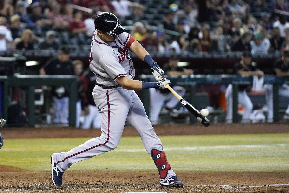 Atlanta Braves' Austin Riley connects for a three-run home run against the Arizona Diamondbacks during the seventh inning of a baseball game Wednesday, June 1, 2022, in Phoenix. (AP Photo/Ross D. Franklin)