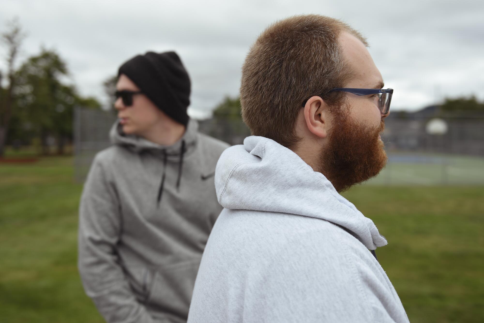 Nick and Jarred Lange stand in a grassy outdoor area.
