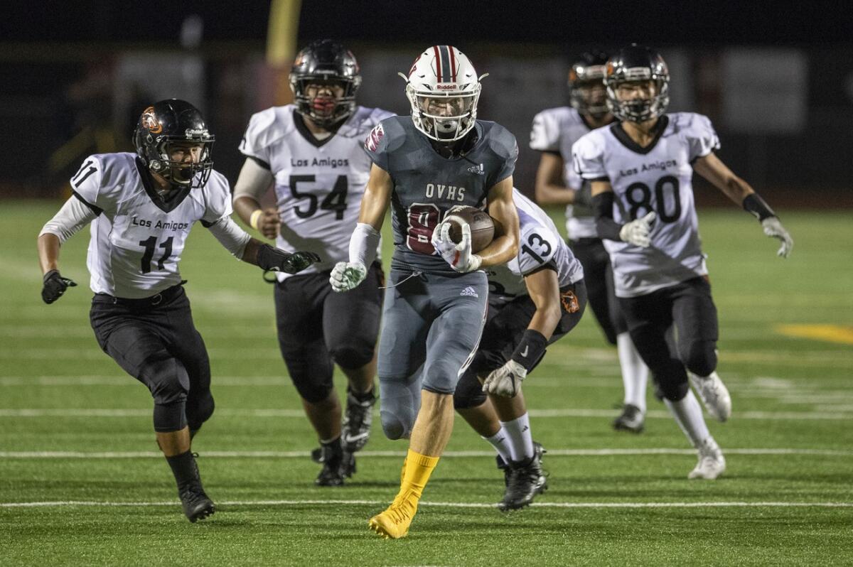 Brandon Alcaraz of Ocean View runs up the field to complete a 32-yard touchdown catch in the second quarter of a nonleague home game against Los Amigos on Friday in Huntington Beach.