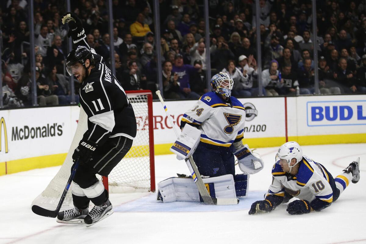 Kings center Anze Kopitar celebrates after teammate Trevor Lewis scored past Blues goalie Jake Allen and winger Scottie Upshall in the first period.