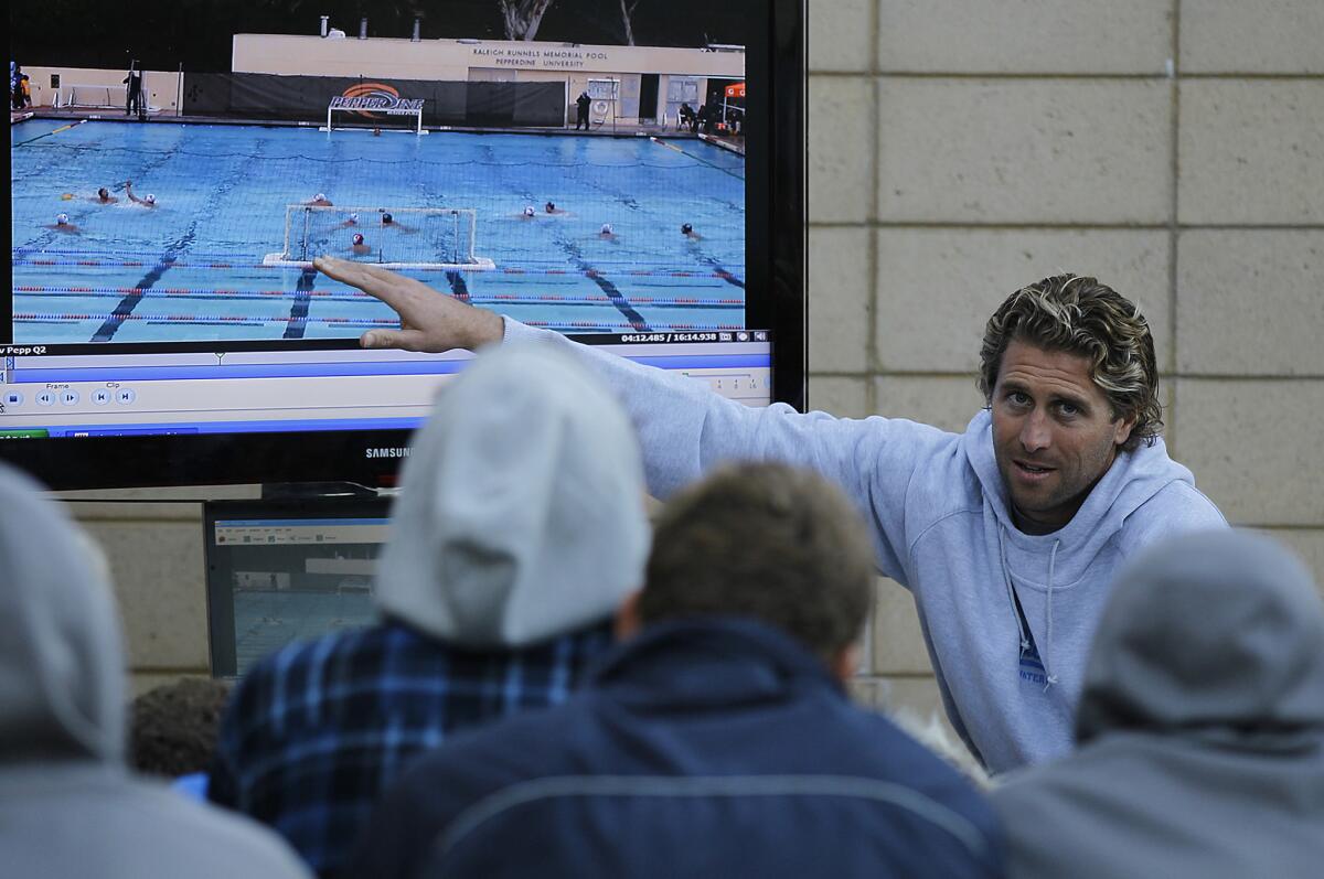 UCLA water polo Coach Adam Wright conducts a film session with his team at a 2011 practice.
