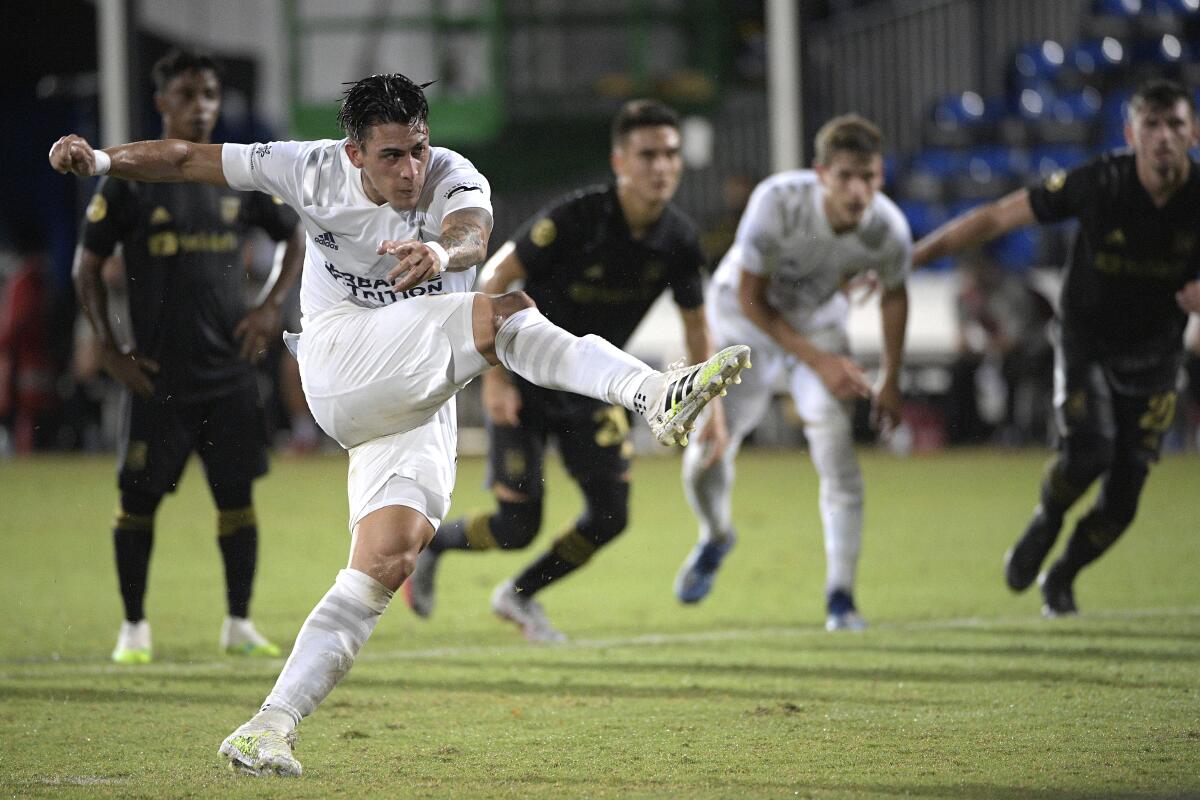 Galaxy forward Cristian Pavon follows through on a penalty kick against the LAFC on July 18, 2020.