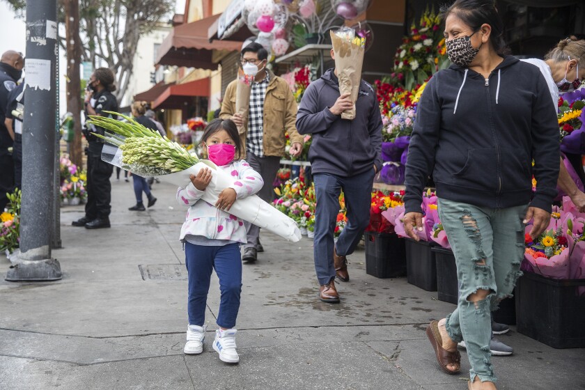 A flower shortage is driving up costs for a Mother's Day of
post-COVID-19 reunions 2 People with bouquets