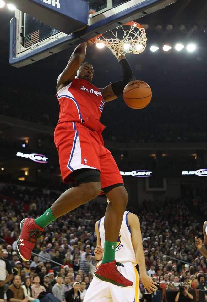 Clippers center DeAndre Jordan finishes a dunk against the Warriors on Sunday.