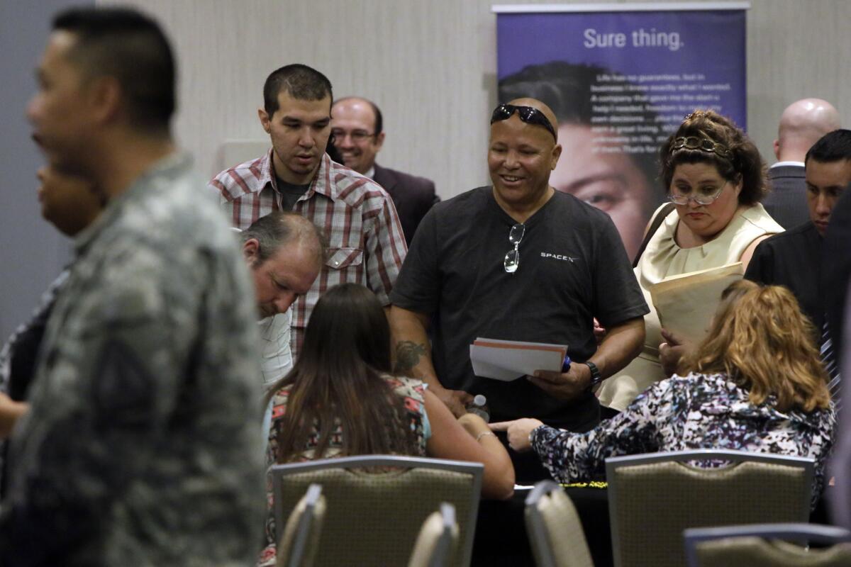 Job seekers gather during Choice Career Fairs' Inland Empire Career Fair at the Doubletree Hotel in Ontario on Sept 9, 2014.