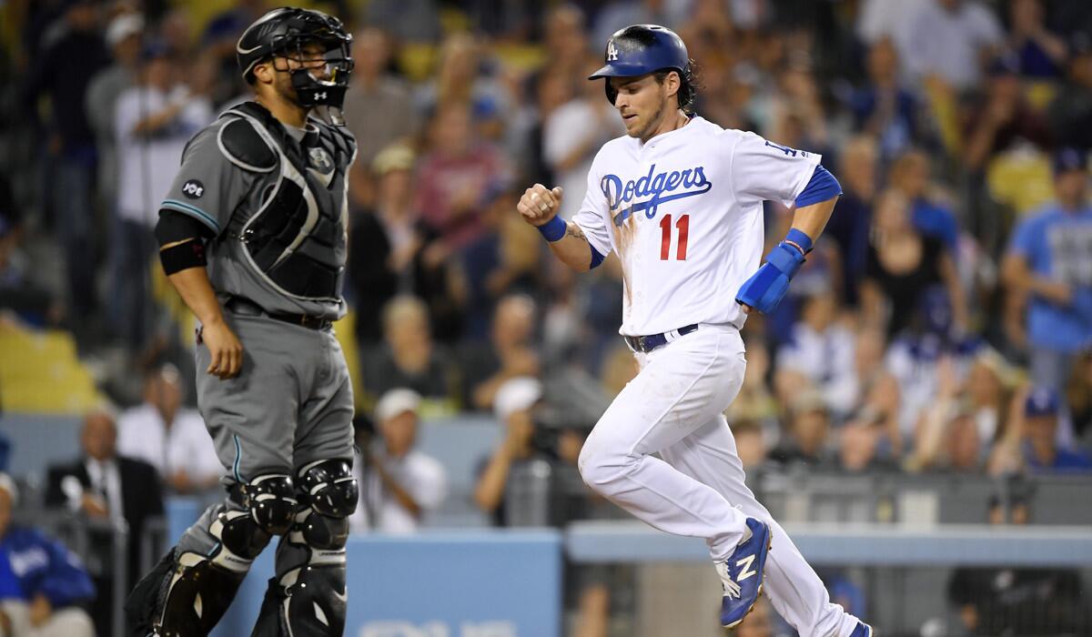 Dodgers' Josh Reddick, right, scores on a single by Andrew Toles as Arizona Diamondbacks catcher Welington Castillo stands at the plate during the third inning Tuesday.