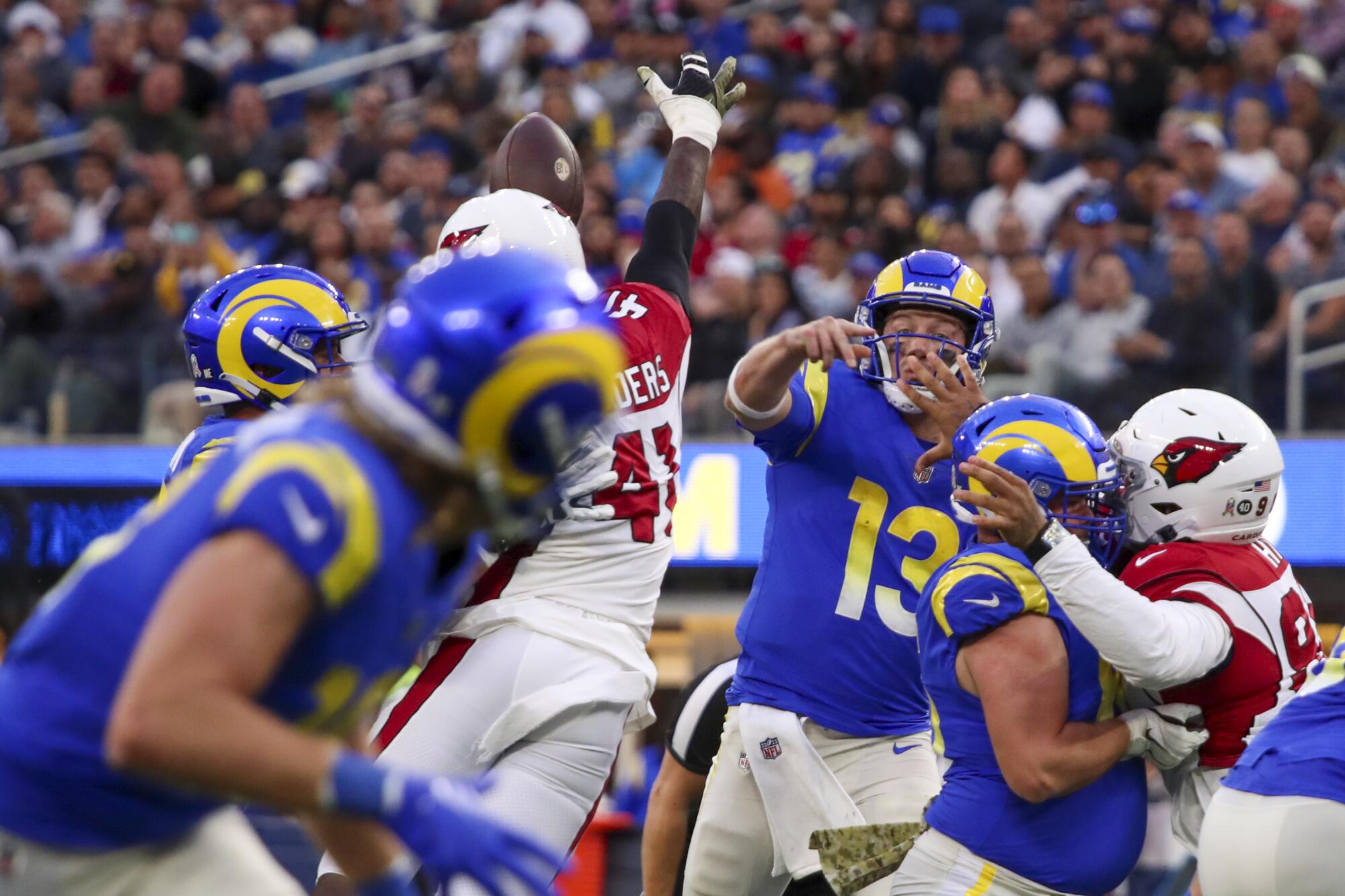Cardinals outside linebacker Myjai Sanders deflects a pass by Rams backup quarterback John Wolford.