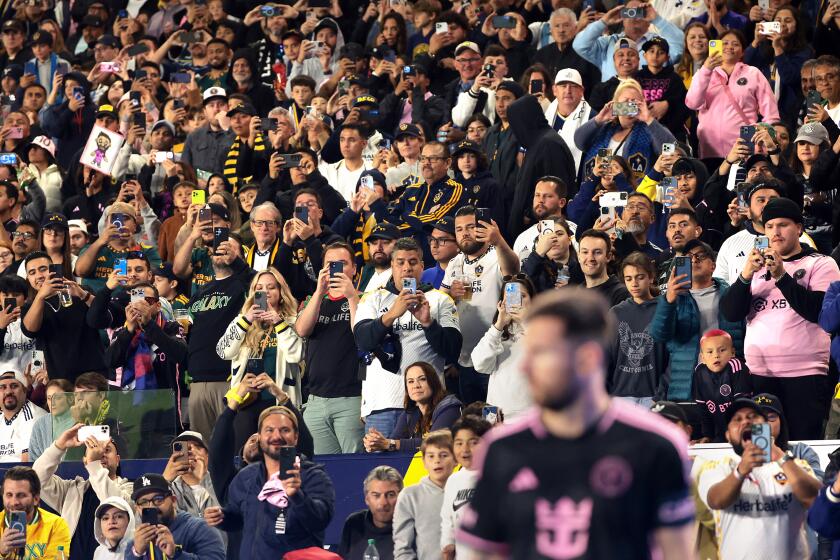 Carson, California February 25, 2024-Fans take pictures and video as Miami's Lionel Messi prepares for a corner kick against Galaxy in the first half at Dignity Health Sport Park Sunday. (Wally Skalij/Los Angeles Times)