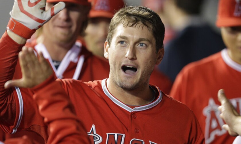 Angels third baseman David Freese celebrates with his teammates after hitting a solo home run against the Seattle Mariners on April 8. Freese says he's not overly concerned about his slow start.