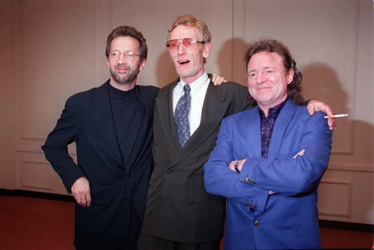 In this 1993 file photo, Eric Clapton, left, Ginger Baker, center, and Jack Bruce pose prior to Cream's Rock & Roll Hall of Fame induction ceremony  in Los Angeles. 