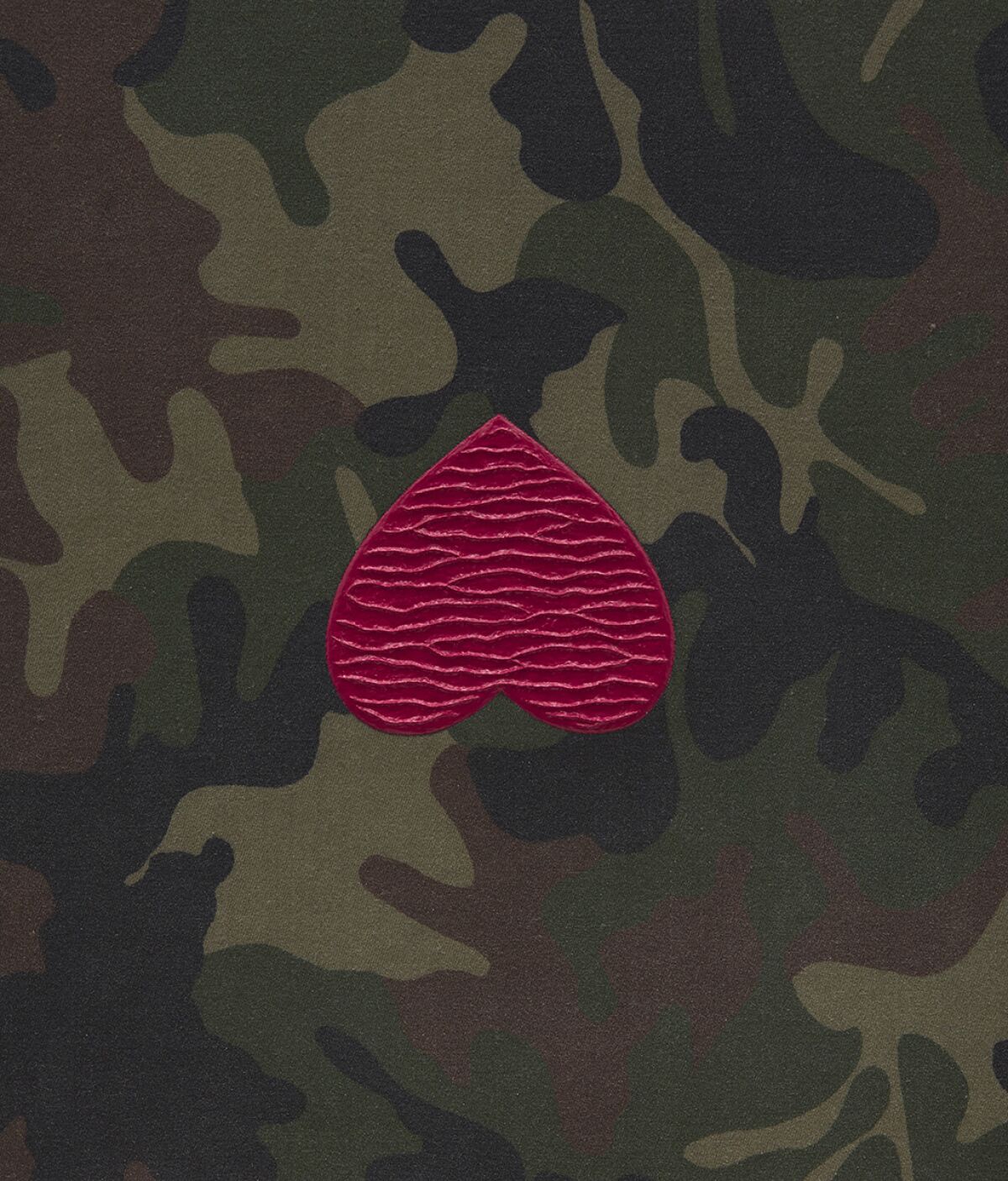 A painting on camouflage in shades of green shows a glittering, upside-down red heart at its middle