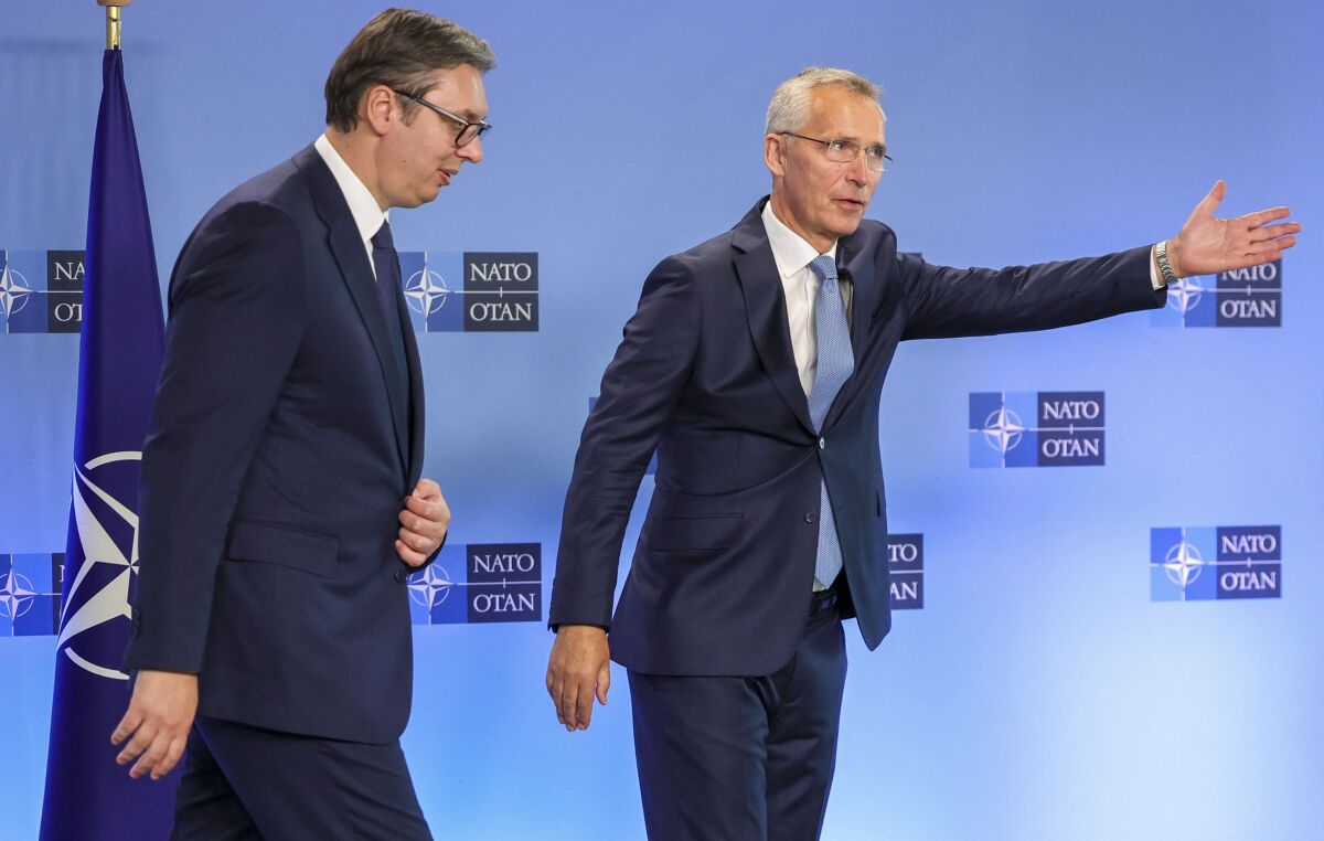 NATO Secretary General Jens Stoltenberg, right, speaks with Serbian President Aleksandar Vucic prior to a meeting at NATO headquarters in Brussels, Wednesday, Aug. 17, 2022. (AP Photo/Olivier Matthys)