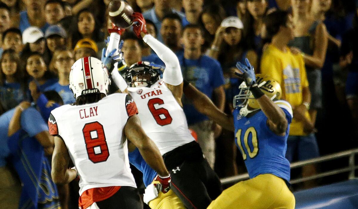 Utah wide receiver Dres Anderson catches a 42-yard touchdown pass from quarterback Kendal Thompson with UCLA's Ishmael Adams and Fabian Moreau defending in the second quarter Saturday at the Rose Bowl.
