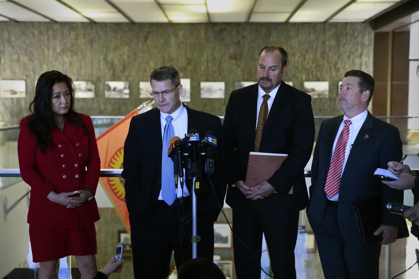 Orange County district attorney Chief of Staff Susan Kang Schroeder, left, Assistant Dist. Atty. Dan Wagner, Senior Deputy Dist. Atty. Scott Simmons and Deputy Dist. Atty. Howard Gundy speak to the media after Judge Thomas Goethals removed their office from the case against Scott Dekraai.