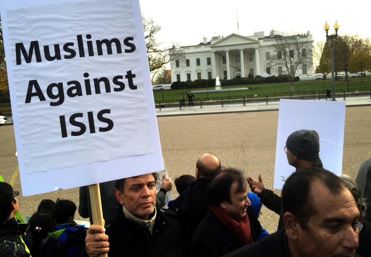 A Muslim holds a banner in protest against Islamic State and the use of terrorism in the name of Islam during a religious procession of American Shiites outside the White House on Dec. 6.