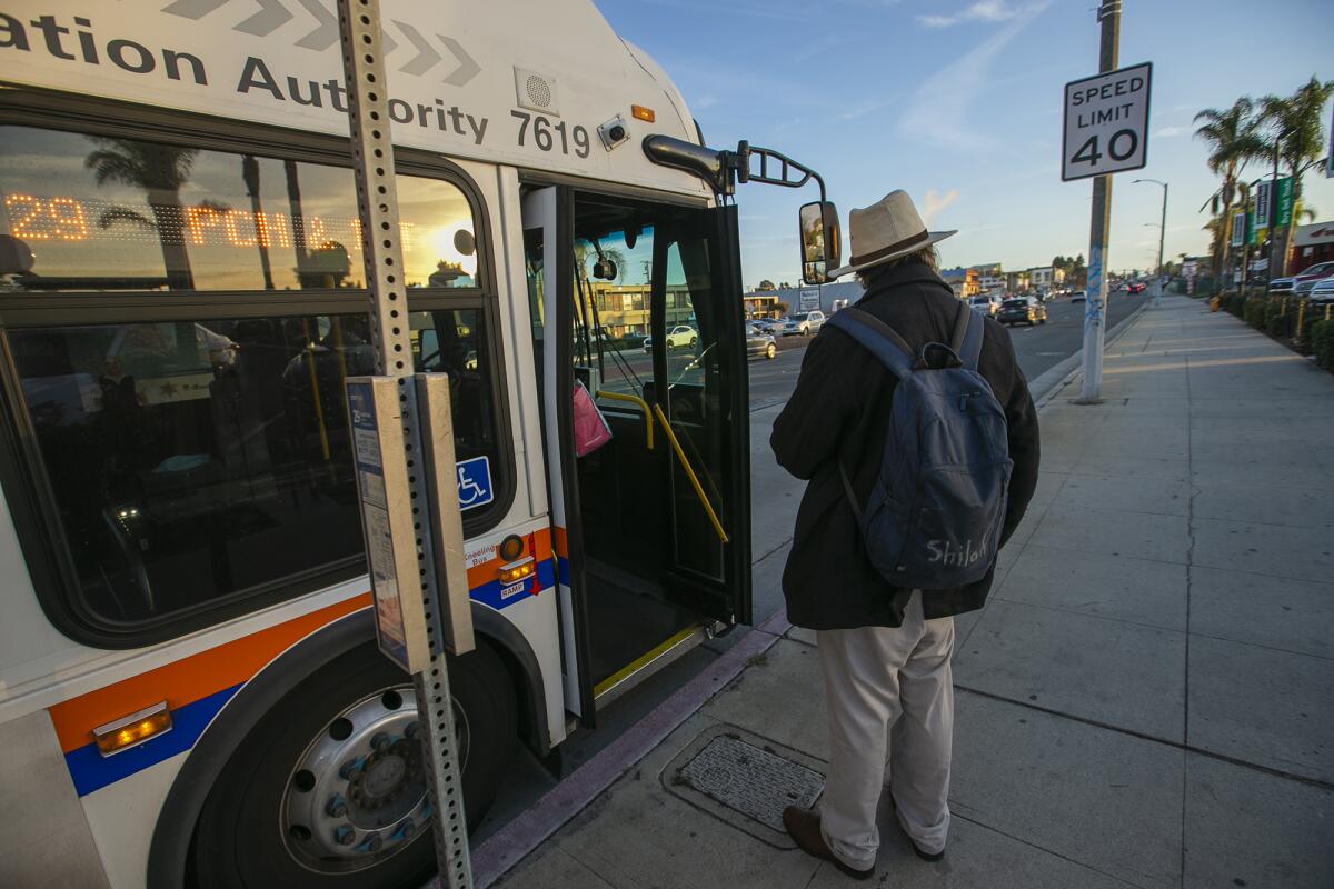 A man boards a bus on Beach Boulevard on Dec. 28, 2022 in Huntington Beach. 