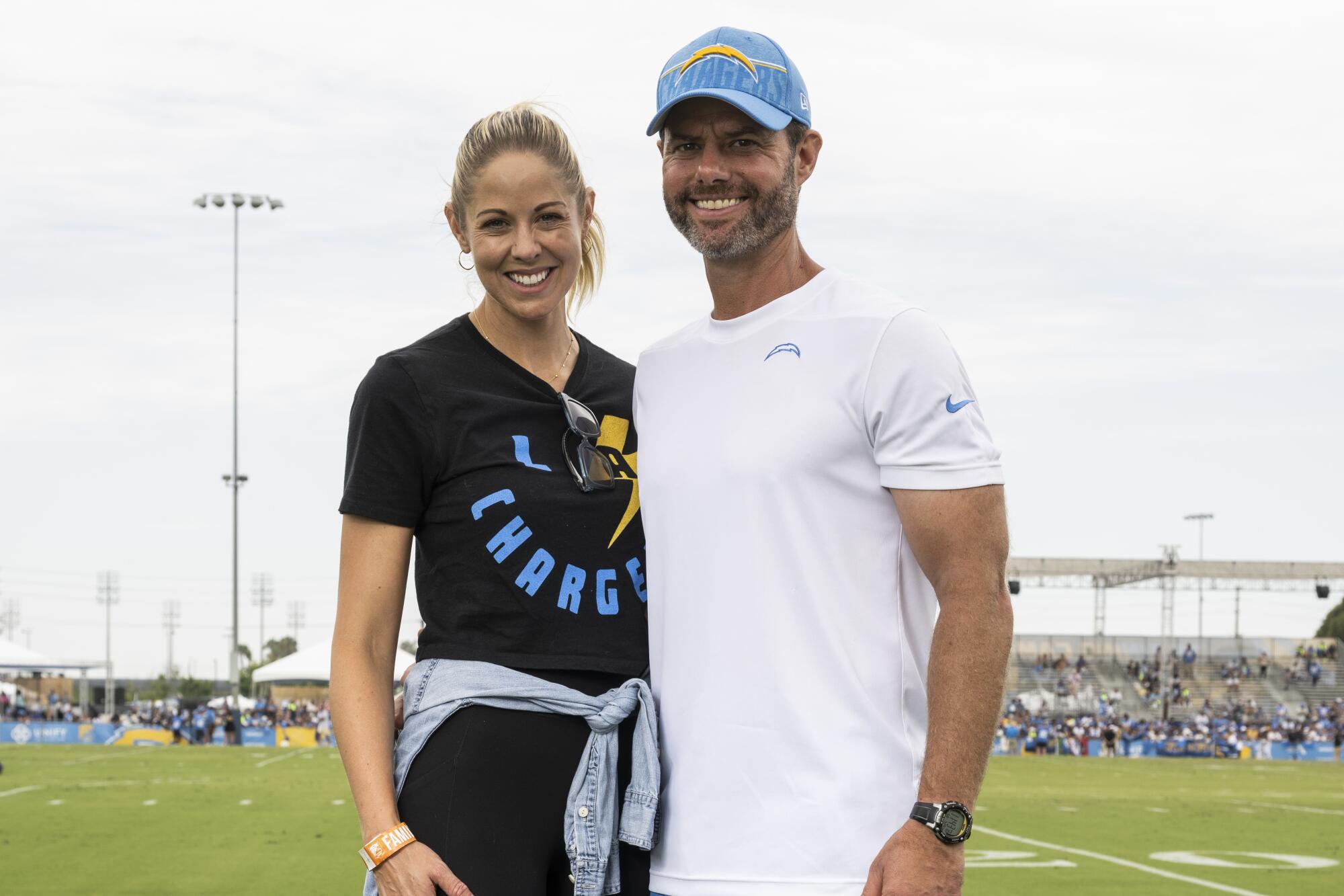 Chargers coach Brandon Staley, right, and his wife Amy smile as they pose for a photo.