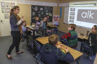 Teacher Kerry Donoghue works with 6th and 7th grade students on a phonics lesson at the New Bridge School on January 30, 2020 in Poway, California. New Bridge caters to students with dyslexia.