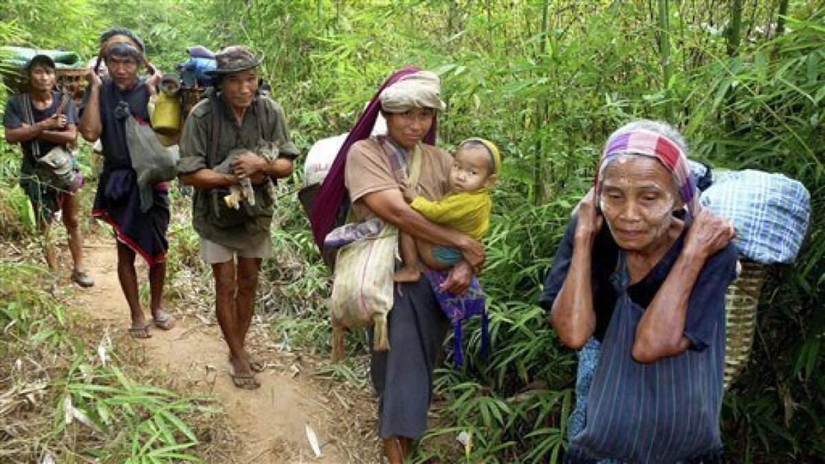 In this Sunday, Jan. 24, 2010 photo released by the Free Burma Rangers, Karen families carry their belongings as they flee Myanmar soldiers in Karen State, Myanmar. Half a million Karen tribespeople have been driven from their homes by the Myanmar military. The country's second largest ethnic minority, the Karens are about 4 million within Myanmar's 43 million. The vice president of the Karen National Union, the insurgency's political organization, says that colonial Britain broke its promise to carve out a separate state for the minority before granting Burma independence in 1949. (AP Photo/Free Burma Rangers)
