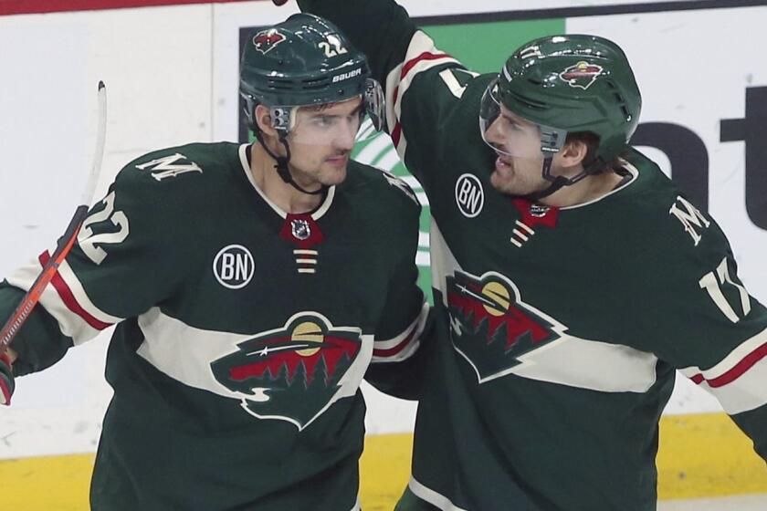 Minnesota Wild's Nino Niederreiter, left, of Switzerland, is congratulated by Marcus Foligno after Niederreiter scored a goal off Los Angeles Kings goalie Jonathan Quick in the second period of an NHL hockey game Tuesday, Jan. 15, 2019, in St. Paul, Minn. (AP Photo/Jim Mone)