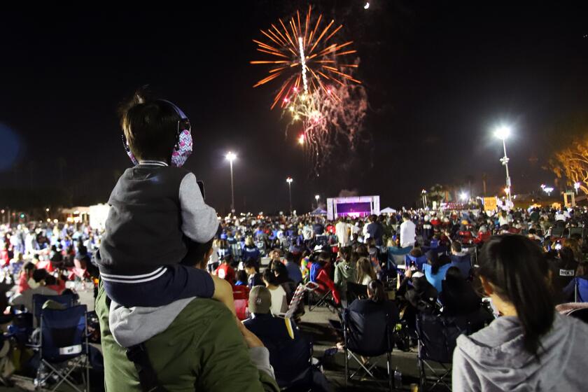 Hundreds of guests watch the firework show during the Independence Day Community Celebration presented by the city of Costa Mesa at the Orange County Fairgrounds and Event Center in Costa Mesa on Sunday, July 3, 2022. The free event featured a firework show with live music and contests for kids. (Photo by James Carbone)