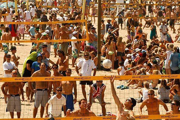Volleyball players compete as crowds flock to the annual Charlie Saikley Six-Man Volleyball Tournament in Manhattan Beach.