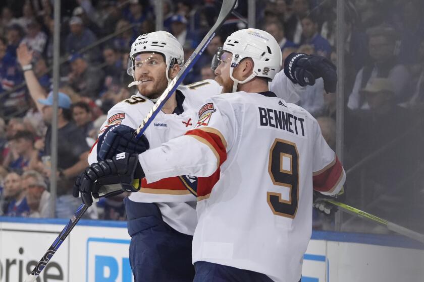Florida Panthers' Matthew Tkachuk, left, celebrates with Sam Bennett after Bennett scored an empty-net goal against the New York Rangers during the third period of Game 5 in the Eastern Conference finals of the NHL hockey Stanley Cup playoffs Thursday, May 30, 2024, in New York, N.Y. The Panthers won 3-2. (AP Photo/Frank Franklin II)