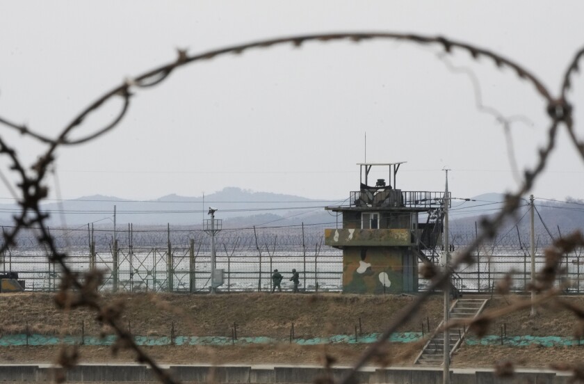 South Korean army soldiers patrol along the barbed-wire fence in Paju, near the border with North Korea, South Korea, Wednesday, Jan. 5, 2022. North Korea fired a suspected ballistic missile into the sea on Wednesday, the South Korean and Japanese militaries said, its first public weapons launch in about two months and a signal that Pyongyang isn’t interested in rejoining denuclearization talks anytime soon and would rather focus on boosting its weapons arsenal. (AP Photo/Ahn Young-joon)