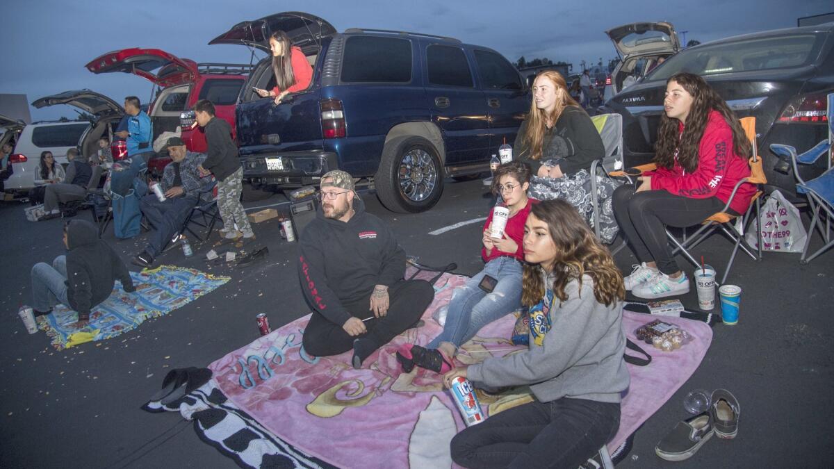 Sometimes all you need is someone to chat with. At the Van Buren, movie-goers watch from the backs of SUVs, or set up blankets and lawn chairs.